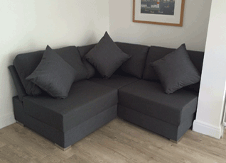 A armless sofa against the wall